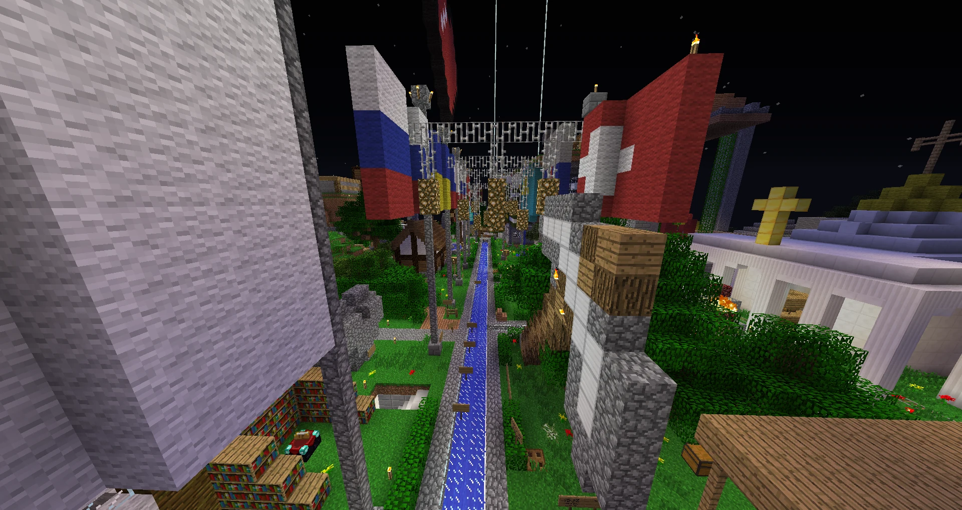 A nighttime street in PublicEvo, with a canal, flags, and player-built houses